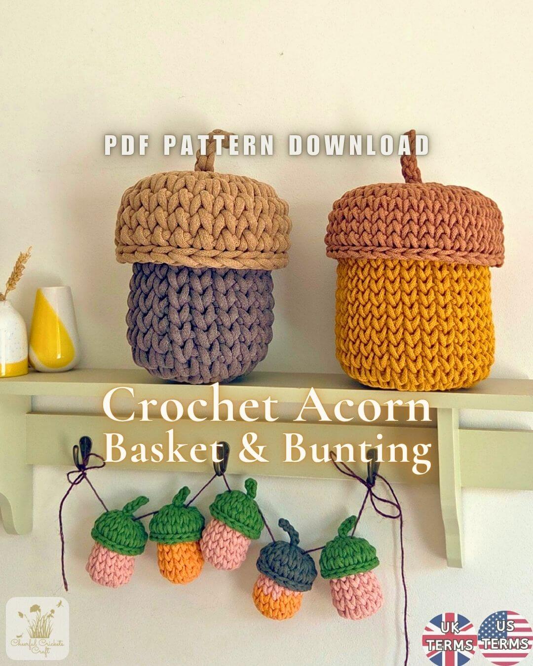 Two crocheted acorn-shaped baskets displayed on a shelf, one in tan and lavender and one in mustard yellow and terracotta, with text reading 'PDF PATTERN DOWNLOAD' and 'Crochet Acorn Basket & Bunting'. Small acorn bunting pieces hang below on hooks against a light wall.