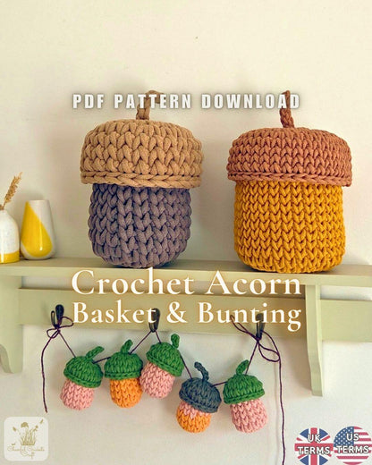 Two crocheted acorn-shaped baskets displayed on a shelf, one in tan and lavender and one in mustard yellow and terracotta, with text reading 'PDF PATTERN DOWNLOAD' and 'Crochet Acorn Basket & Bunting'. Small acorn bunting pieces hang below on hooks against a light wall.