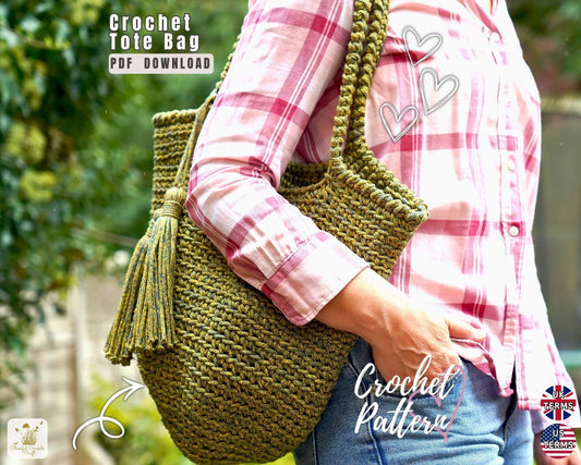 A person wearing a pink plaid shirt carries a large olive green crocheted tote bag with tassel detail, shown outdoors with text overlays reading 'Crochet Tote Bag PDF Download' and 'Crochet Pattern'.