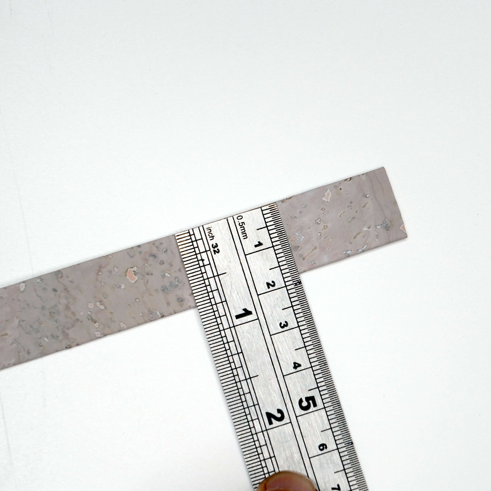 Metal try square with ruler on a white background