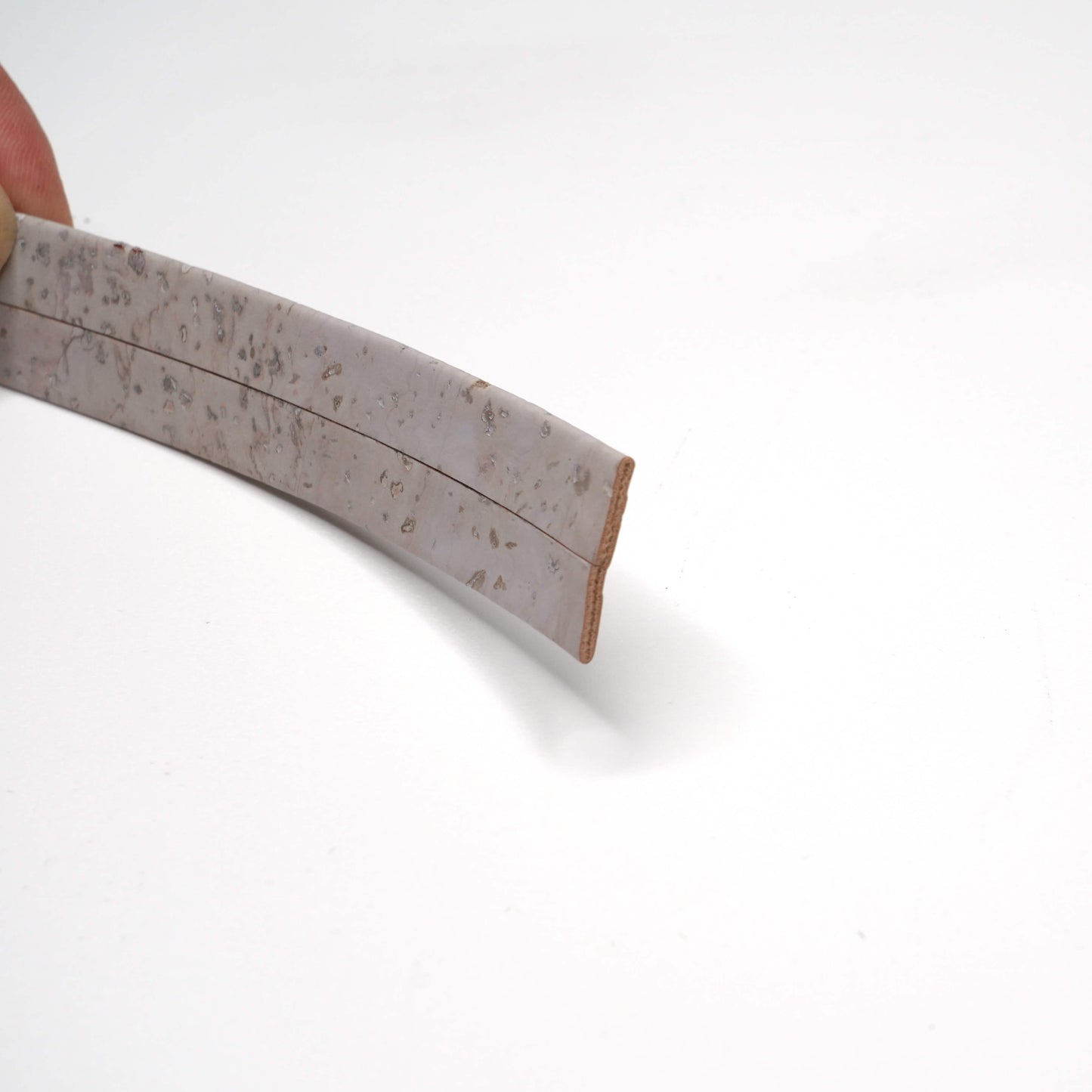 Close-up of a wooden tool handle with a white background