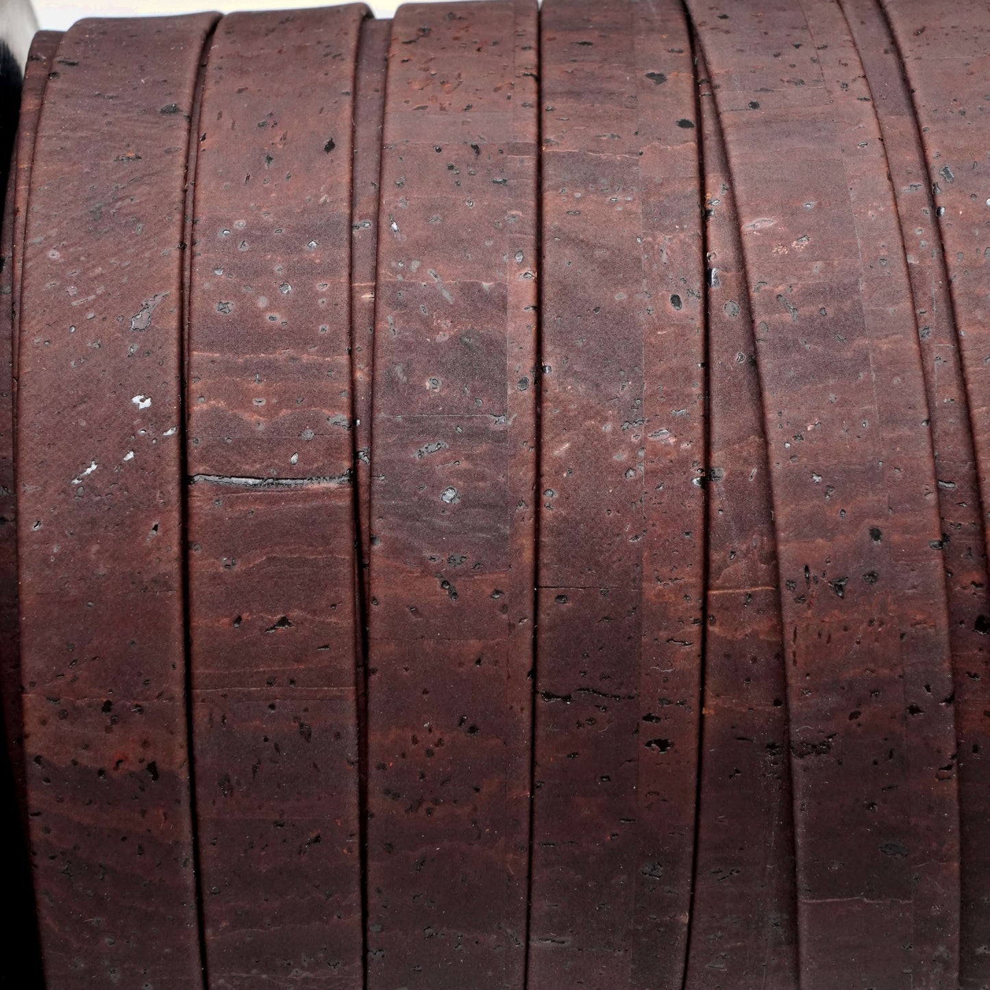 Close-up of a wooden reel with a textured surface