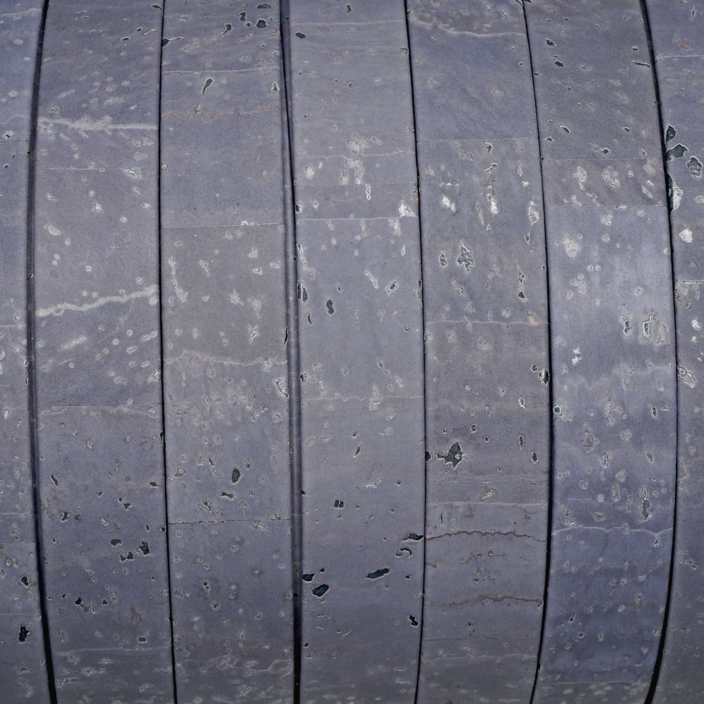 Close-up of a tire tread pattern with visible wear and damage.