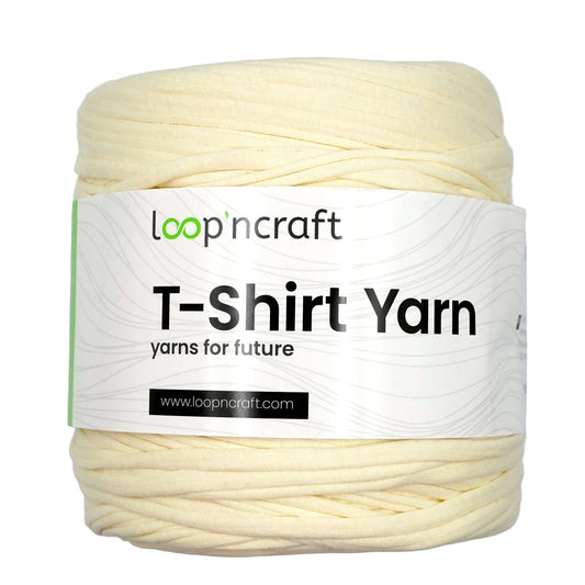 A skein of cream-colored T-shirt yarn with a white paper label that reads 'loop'ncraft T-Shirt Yarn' on a light gray background.