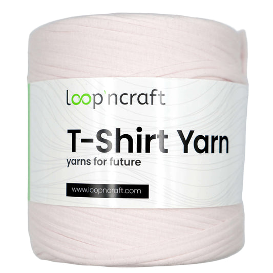 A spool of LoopinCraft T-Shirt Yarn in a pale pink color, featuring a white paper label with the brand name and product details.