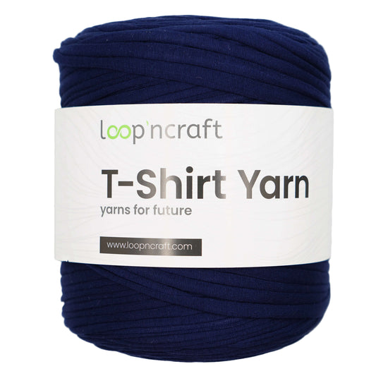 A skein of Loop'n Craft T-Shirt Yarn in a deep navy blue color, wrapped with a white paper label showing the brand name and product details.