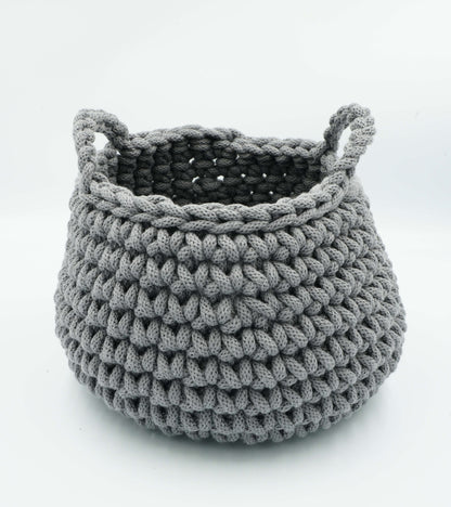 Gray crocheted basket with handles on a white background