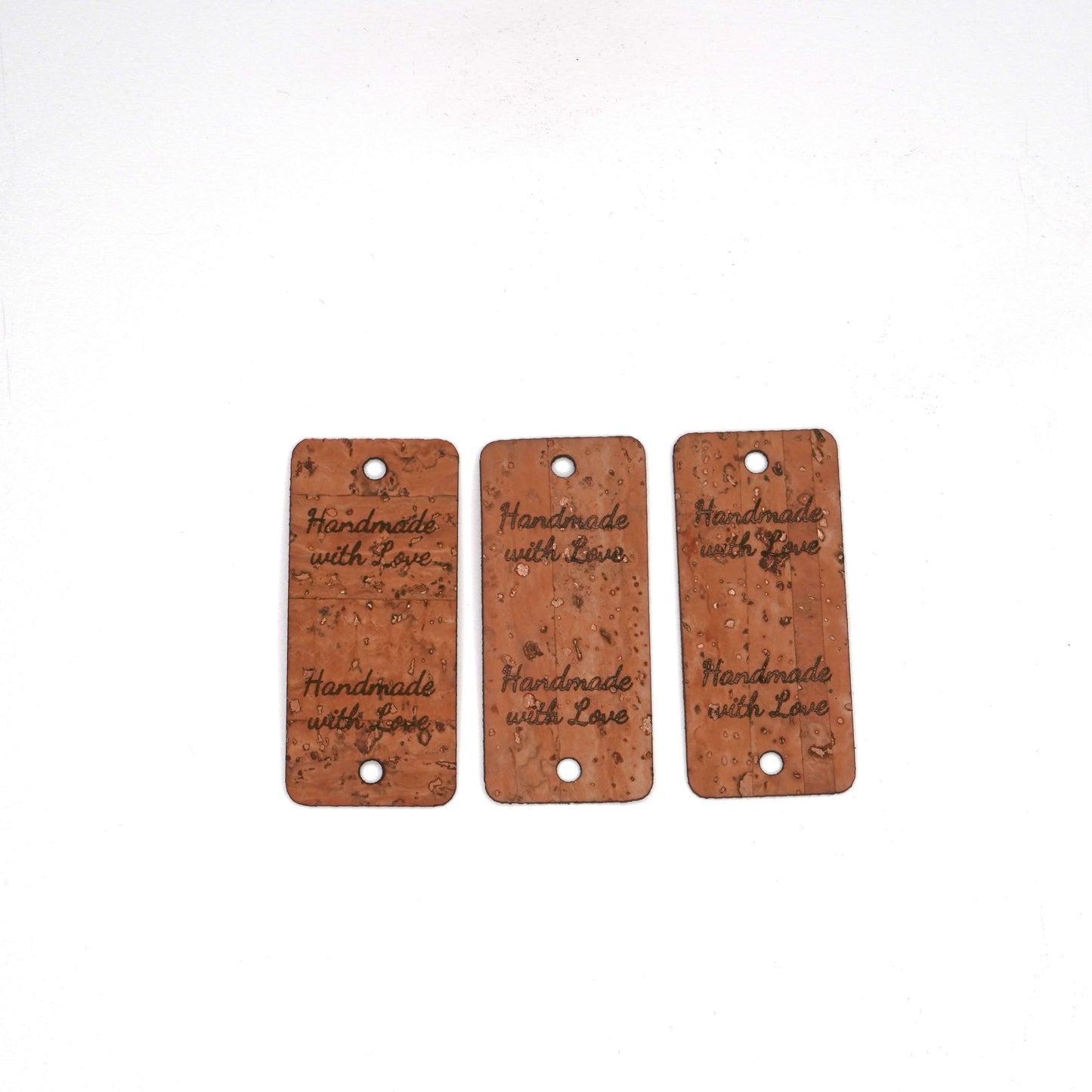 Three cork tags with 'Handmade with Love' text on a white background