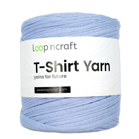 A skein of light blue t-shirt yarn with a white paper label that reads 'loop'ncraft T-Shirt Yarn', set against a plain light gray background.