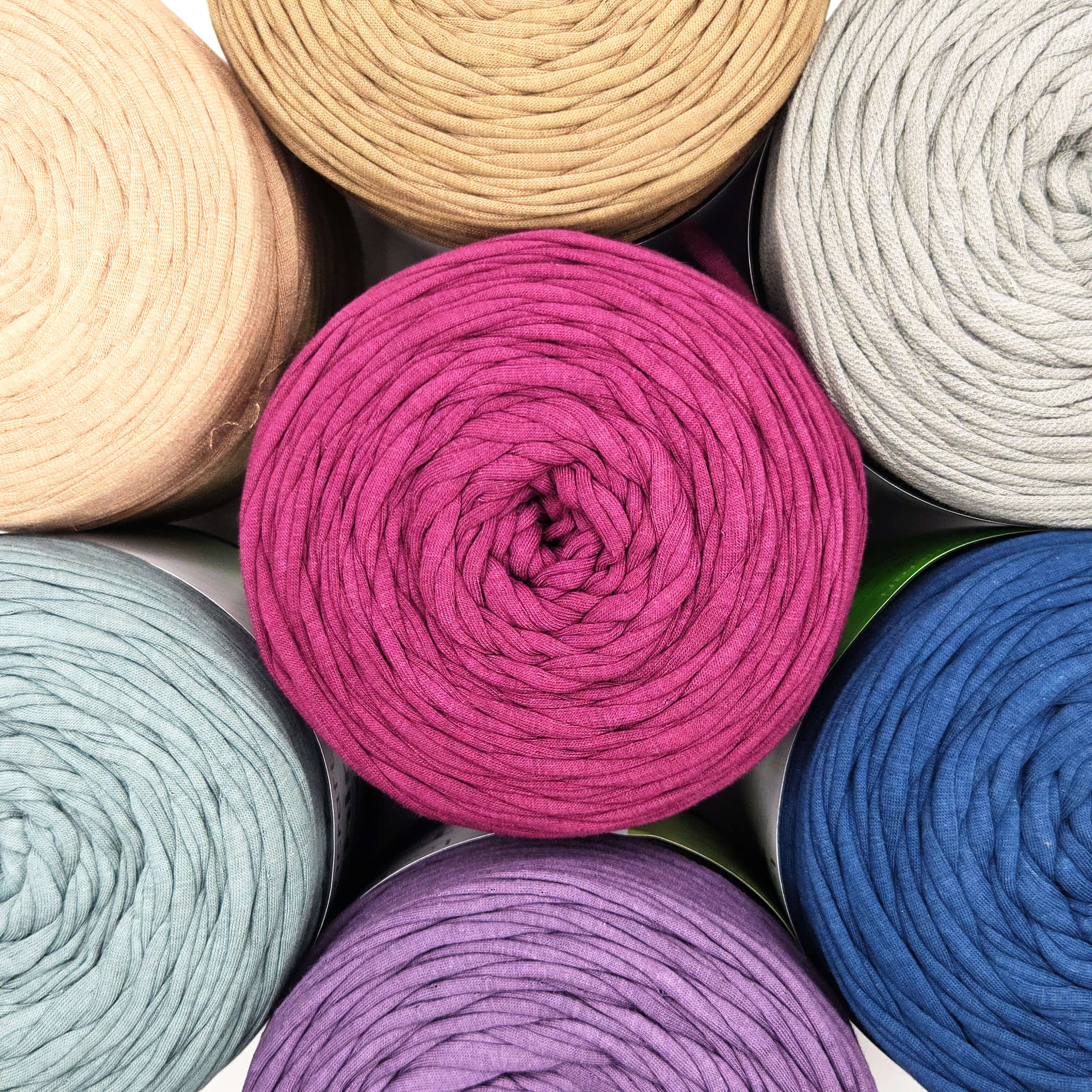 Assorted colorful yarn rolls arranged in a pattern